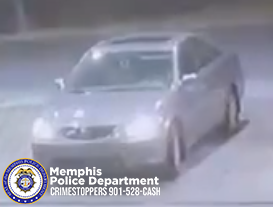 A blurry surveillance-style image showing a light-colored sedan parked or moving slowly in a dimly lit area at night. The vehicle is viewed from the front-left angle. The Memphis Police Department seal appears in the bottom-left corner, along with white text that reads “Memphis Police Department CRIMESTOPPERS 901-528-CASH.”