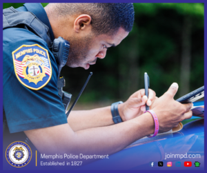 A Memphis Police Department officer is shown from the side, leaning over the hood of a police vehicle while writing on a notepad and holding a handheld device. The officer’s uniform displays an MPD shoulder patch and a radio is attached to the uniform. The background is filled with greenery. At the bottom of the image, the Memphis Police Department seal appears alongside the text “Memphis Police Department – Established in 1827,” the website joinmpd.com, and several social media icons.