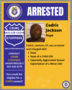 A rectangular poster with a blue and gold color scheme displays the word “ARRESTED” at the top in large white letters. The upper-left corner shows the Memphis Police Department seal. Below, on the left side, there is a blue Crime Stoppers badge graphic with the text “CRIME STOPPERS 901-528-CASH” and the website “www.crimestopmem.org.” Below that is additional text: “CONTACT CRIME STOPPERS ANONYMOUSLY 901-528-2274” and “You could be eligible for a CASH reward!”
On the right side of the poster, there is a booking photo area with height chart lines behind the person. Next to it, text reads: “Cedric Jackson” and below that, “Rape.” Further down, additional text states: “Cedric Jackson, 47, was arrested and charged with:” followed by three bullet points: “Rape,” “Rape of a Child (3X),” and “Especially Aggravated Sexual Exploitation of a Minor (3X).” A small Memphis Police Department seal appears in the bottom-right corner of the poster.