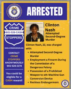 A graphic from the Memphis Police Department featuring the headline “ARRESTED” at the top. The left side shows the Crime Stoppers badge logo with the text “CRIME STOPPERS 901-528-CASH” and the website “www.crimestopmem.org,” along with a message encouraging anonymous contact for tips and the possibility of a cash reward.
To the right is a booking-style photograph of an individual standing in front of height measurement lines. Next to the photo is text stating:
“Clinton Nash
Attempted Second-Degree Murder
Clinton Nash, 22, was charged with:” followed by bullet points:
• Attempted Second-Degree Murder
• Employment a Firearm During the Commission of a Dangerous Felony
• Possession of a Prohibited Weapon to wit: Machine Gun Conversion Device
• Reckless Endangerment
The background uses yellow and blue colors with Memphis Police Department seals in the corners.