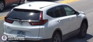 A photo shows a white Honda CR‑V traveling on a roadway. The vehicle is viewed from the rear passenger side, and the license plate is visible, displaying the text “AHZ 40V.” The car is in a traffic lane with another vehicle partially visible ahead. In the bottom left corner, there is the Memphis Police Department seal and text that reads: “Memphis Police Department. Crimestoppers 901‑528‑CASH.”