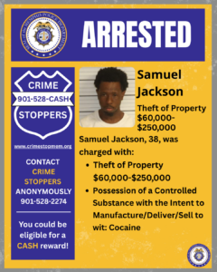 A rectangular poster with a blue and yellow color scheme. At the top, a wide blue banner displays the word “ARRESTED” in large white letters. To the left of the banner is a circular seal labeled “City of Memphis Police Department.” Below, on the left side, there is a large blue shield-shaped graphic with white text that reads: “CRIME STOPPERS 901-528-CASH.” Under the shield is the website “www.crimestopmem.org,” followed by additional text: “CONTACT CRIME STOPPERS ANONYMOUSLY 901-528-2274 You could be eligible for a CASH reward!” To the right of the shield graphic, there is a rectangular photo showing one individual posed against a height chart background. To the right of the photo, black text reads: “Samuel Jackson Theft of Property $60,000–$250,000 Samuel Jackson, 38, was charged with: • Theft of Property $60,000–$250,000 • Possession of a Controlled Substance with the Intent to Manufacture/Deliver/Sell to wit: Cocaine” A small Memphis Police Department seal appears in the bottom right corner of the poster.