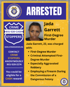A poster with a Memphis Police Department seal at the top and the large heading “ARRESTED.” Below, on the left, there is a “Crime Stoppers” badge graphic with the phone number 901-528-CASH and website www.crimestopmem.org. Text encourages contacting Crime Stoppers anonymously and mentions eligibility for a cash reward. In the center is a booking-style photograph of an adult individual. To the right of the photograph is text reading “Jada Garrett, First-Degree Murder.” Additional text states that this person, age 22, was charged with first-degree murder, criminal attempted first-degree murder, especially aggravated robbery, and employing a firearm during the commission of a dangerous felony. The background uses blue, gold, and purple colors with Memphis Police Department logos.