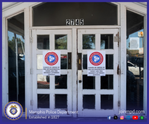 A set of white double doors with multiple glass panes is shown with two official notices taped to the front, one on each door. Each notice displays a circular emblem with three stars and the text “District Attorney General, Shelby County, Tennessee.” Beneath the emblem, the notices read, “Closed by order of the Environmental Court and the District Attorney General.” The doors are labeled with the number “2745” above the frame. Reflections in the glass show parts of the surrounding area. At the bottom of the image are the Memphis Police Department seal, the text “Memphis Police Department — Established in 1827,” the website “joinmpd.com,” and several social media icons.